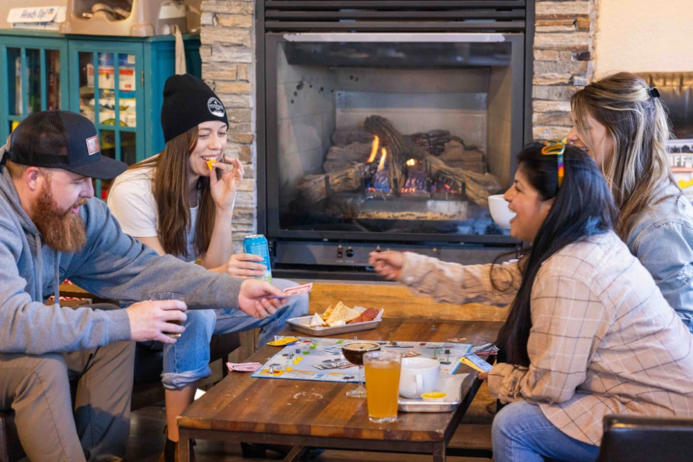 group of friends eating snacks and playing boardgames during Happy Hour at Kickstand Kafe